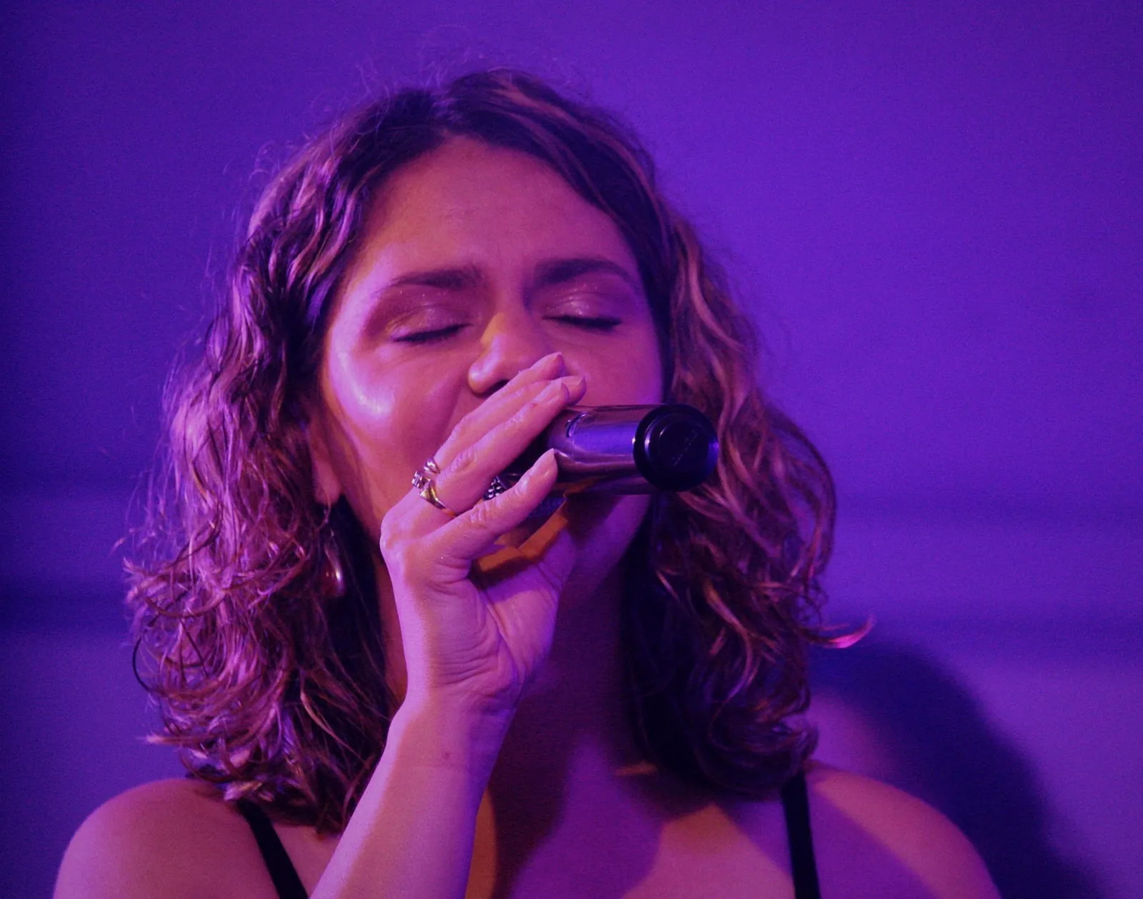 Une chanteuse de Watts Up au micro, ambiance intime